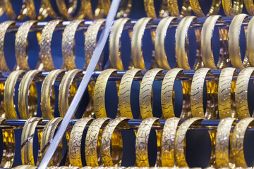 Jewelry shop window with a huge selection of gold jewelry bracelets, chains