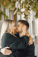 Fototapeta premium Happy young couple hugging and kissing outdoors