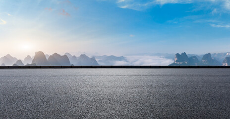 Asphalt highway and mountain natural scenery at sunset. Road and mountain background.