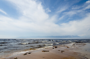 Waves on the shore of the lake. Mountain view.