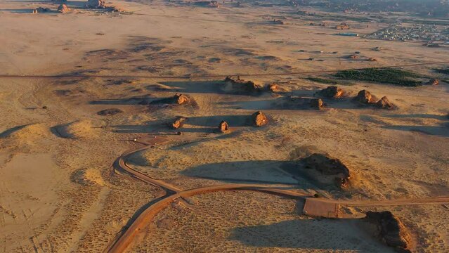 Aerial view of Madain Saleh, Al-Ḥijr or Hegra, archaeological site located in Al-Ula, Al Madinah Region, Hejaz, Saudi Arabia - wide, panoramic, drone shot