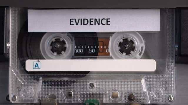 Audio Cassette Tape With Evidence Recording Rolling in Deck Player, Close Up