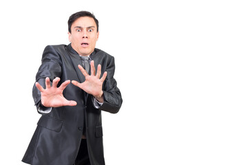 Shocked businessman gesturing and looking at camera with scared face