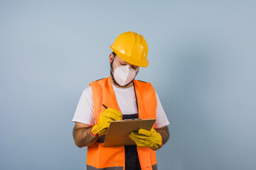 Hispanic man Professional engineering and worker with helmet and face mask for coronavirus pandemic in Mexico Latin America