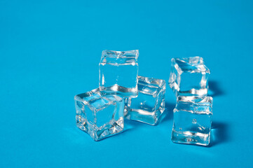 Clear ice cubes for cooling drinks on a blue background.