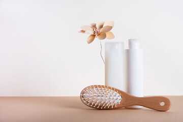 Shampoo and conditioner bottles with hair brush on white background. Hair care concept, natural...
