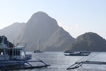 Tourist banca boats with background limestone island in Bacuit Bay, Palawan, Philippines. 