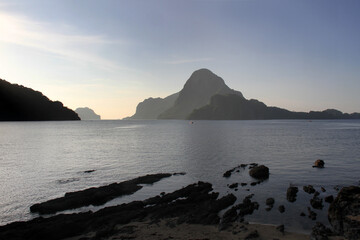 Scenic view of bacuit bay in the morning with background silhouette of lime stone islands. 