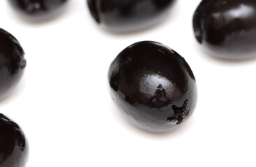 Black olives isolated on a white background.
