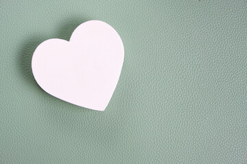 Fototapeta premium White heart green background.Festive background for Valentines Day.