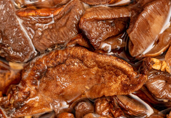 Dried mushrooms in water as background.