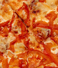 Pizza with tomato and cheese as background.