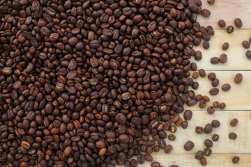Fototapeta na wymiar dark brown roast coffee beans on wooden board