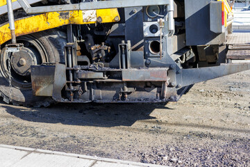 Fototapeta na wymiar Image of an asphalt finisher preparing a sidewalk