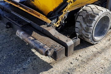 Image of an asphalt finisher preparing a sidewalk