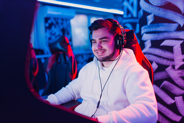 Guy playing gaming game on computer at game club.