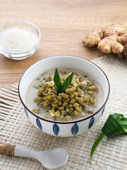 Mung Bean Porridge or Bubur Kacang Hijau, Indonesian dessert porridge of mung beans with coconut milk, pandan leaf and ginger. Served in bowl.
