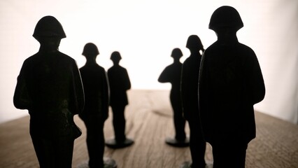 Army, military, metal figures of soldiers 4k. Toy soldiers on a black background. Military theme.