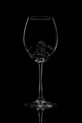 An empty wine glass on a black background