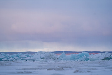 Blue Ice Chunks on Lake Michigan - Frozen Lake with snow, beautiful colorful sky, and clouds in the background