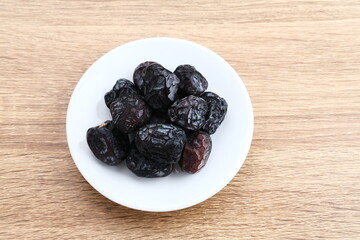 Kurma Ajwa, Ajwa Dates, served in small plate. Kurma Ajwa is one of the special fruit of Arabic.