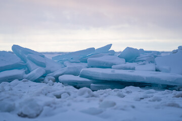 Blue Ice Chunks on Lake Michigan - Frozen Lake with snow, beautiful colorful sky, and clouds in the background