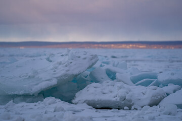 Blue Ice Chunks on Lake Michigan - Frozen Lake with Sunset, clouds, and mountains in the background