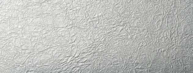 しわ加工のある銀色の紙の背景テクスチャー