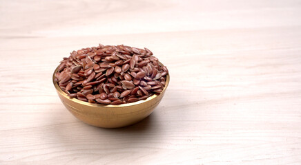 Brown flax seed or linseed on wooden background. Diet healthcare healthy food.
