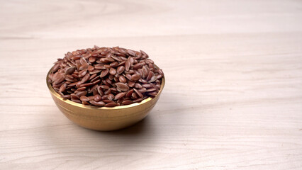 Brown flax seed or linseed on wooden background. Diet healthcare healthy food.
