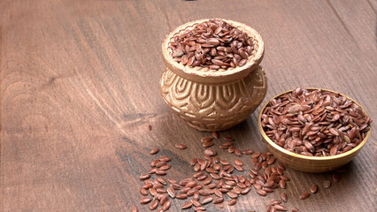 Brown flax seed or linseed on wooden background. Diet healthcare healthy food.
