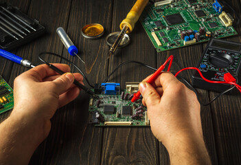 Electronics equipment repair service. Repair of electronic boards. A master with a soldering iron...