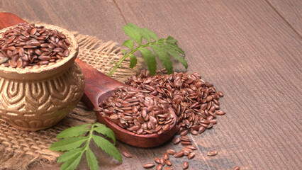 Fototapeta na wymiar Brown flax seed or linseed on wooden background. Diet healthcare healthy food.