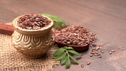 Brown flax seed or linseed on wooden background. Diet healthcare healthy food.