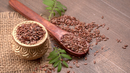Brown flax seed or linseed on wooden background. Diet healthcare healthy food.
