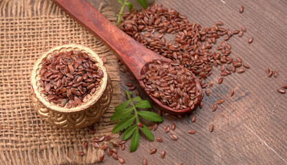 Brown flax seed or linseed on wooden background. Diet healthcare healthy food.