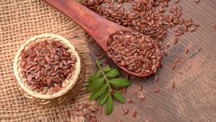 Brown flax seed or linseed on wooden background. Diet healthcare healthy food.