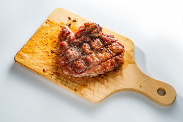 Pork steak cooked on a wooden cutting board