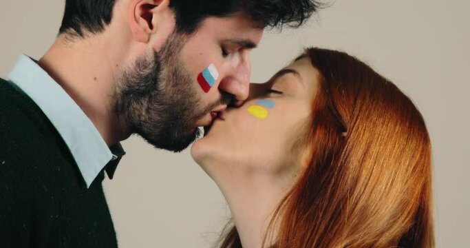Couple with Russian and Ukraine flag are kissing, concept of peace and stop war