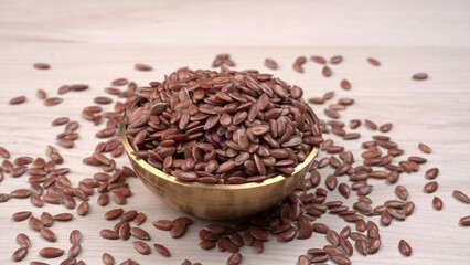 Brown flax seed or linseed on wooden background. Diet healthcare healthy food.