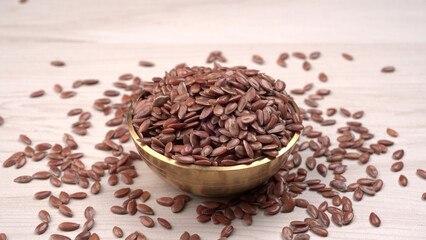 Brown flax seed or linseed on wooden background. Diet healthcare healthy food.
