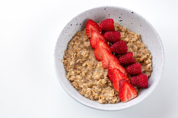 Oatmeal with strawberries and raspberries without milk for a fitness breakfast. Proper nutrition concept.
Vegan food. Healthy food.
