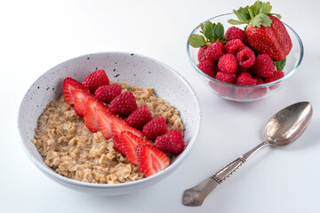 Oatmeal with strawberries and raspberries without milk for a fitness breakfast. Proper nutrition concept.
Vegan food. Healthy food.
