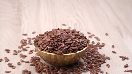 Brown flax seed or linseed on wooden background. Diet healthcare healthy food.