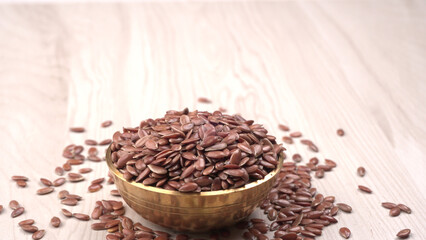 Brown flax seed or linseed on wooden background. Diet healthcare healthy food.