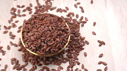 Brown flax seed or linseed on wooden background. Diet healthcare healthy food.
