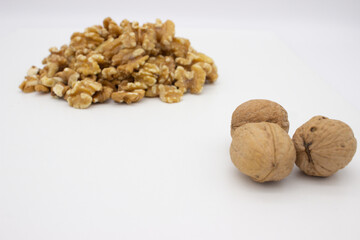 Peeled walnuts on white background
