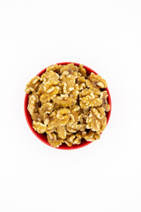 Peeled walnuts in red plate