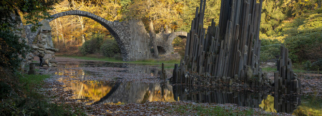 Bridge in rhododendron park in Kromlau in a beautiful autumn mood