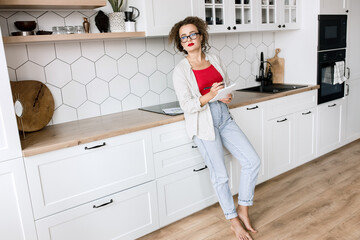 Fototapeta na wymiar Beautiful business woman work at home, using laptop, smiling. Stylish young female employee working remotely on new project, making a financial report or presentation